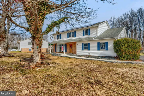 a large tree in front of a house