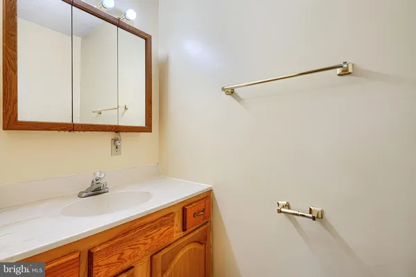a bedroom with a bed and a large mirror on the dresser