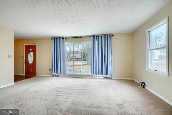 a view of a room with wooden floor furniture and a window
