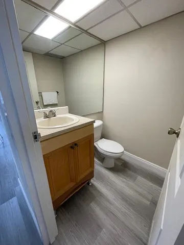 a utility room with a sink toilet and a window