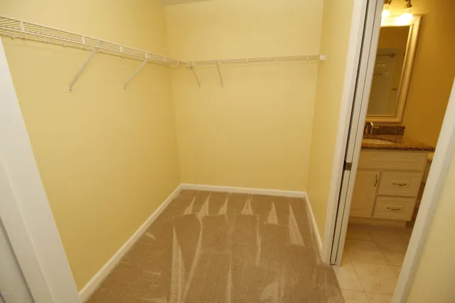 a bathroom with a granite countertop sink a toilet and a mirror