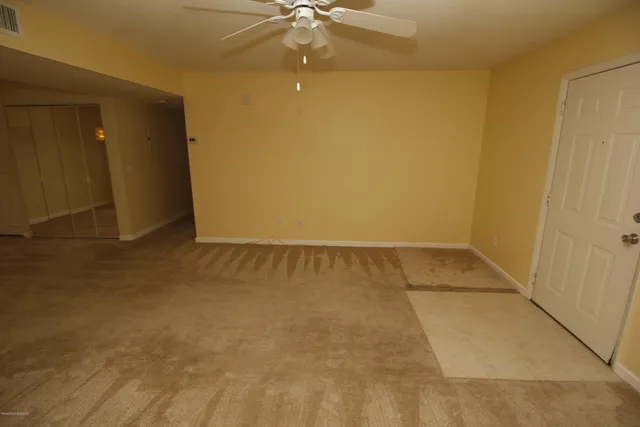an empty room with a empty space and a ceiling fan
