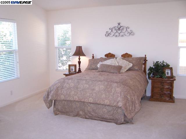 103 Pearlgrass Court San Ramon, CA 94582 - Photo 5 of 8 a large bed sitting in a bedroom next to a window