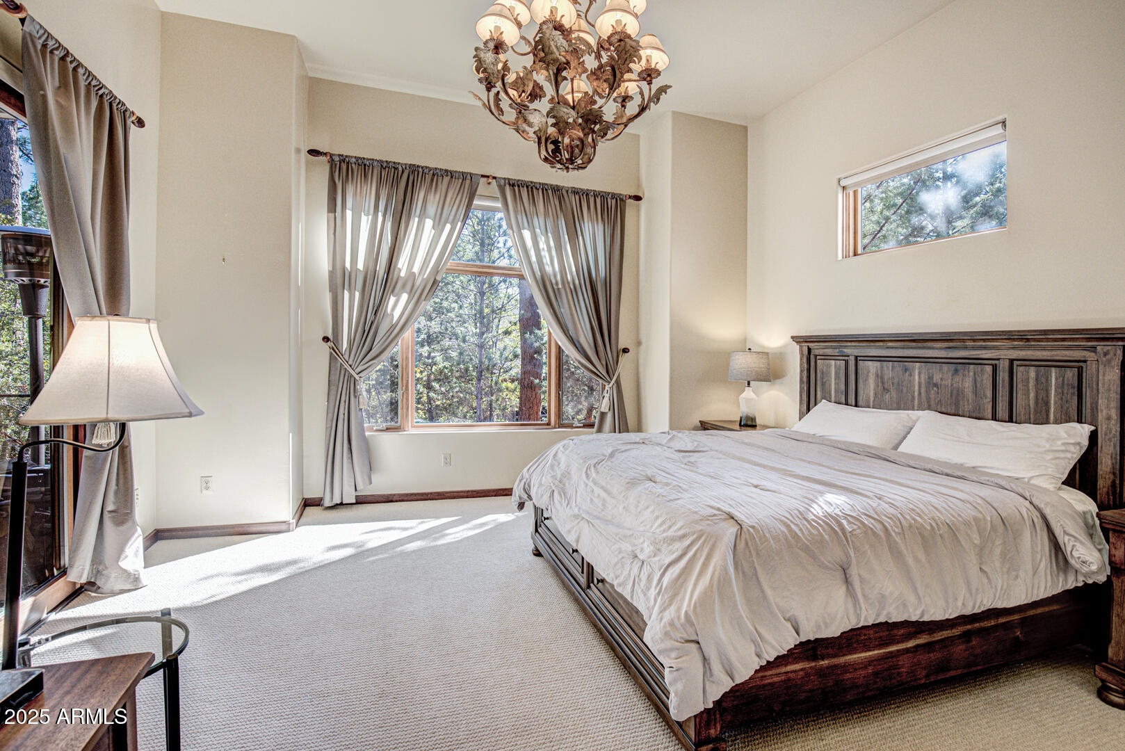 500 North Grapevine Drive Payson, AZ 85541 - Photo 12 of 55 a bedroom with a bed and a chandelier