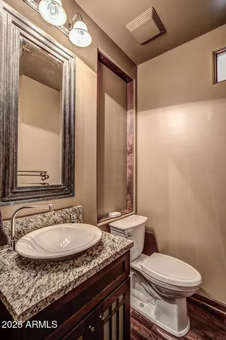 a white toilet sitting next to a small bathroom