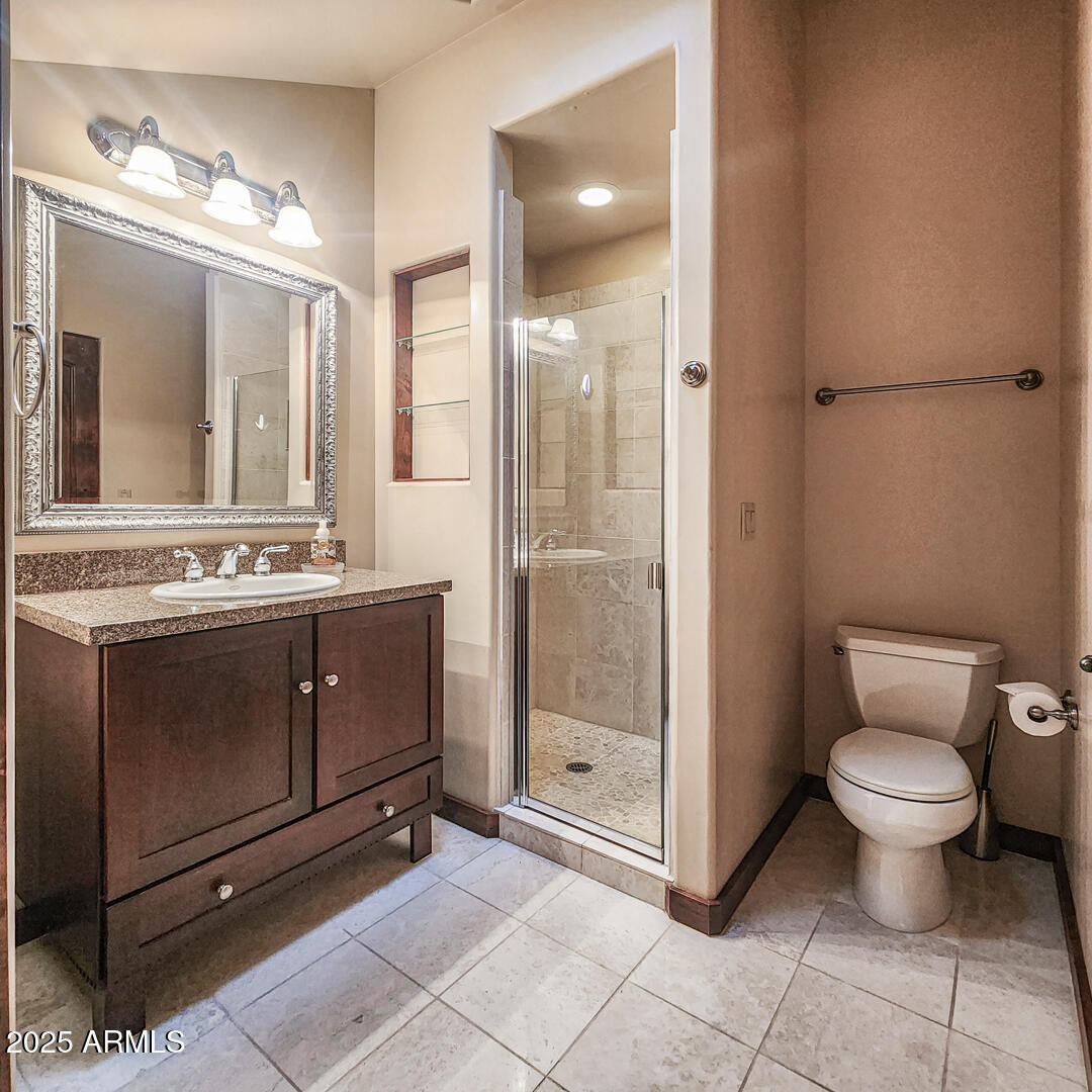 500 North Grapevine Drive Payson, AZ 85541 - Photo 37 of 55 a bathroom with a toilet sink vanity and mirror