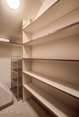 an aerial view of a house with a yard and parking spaces