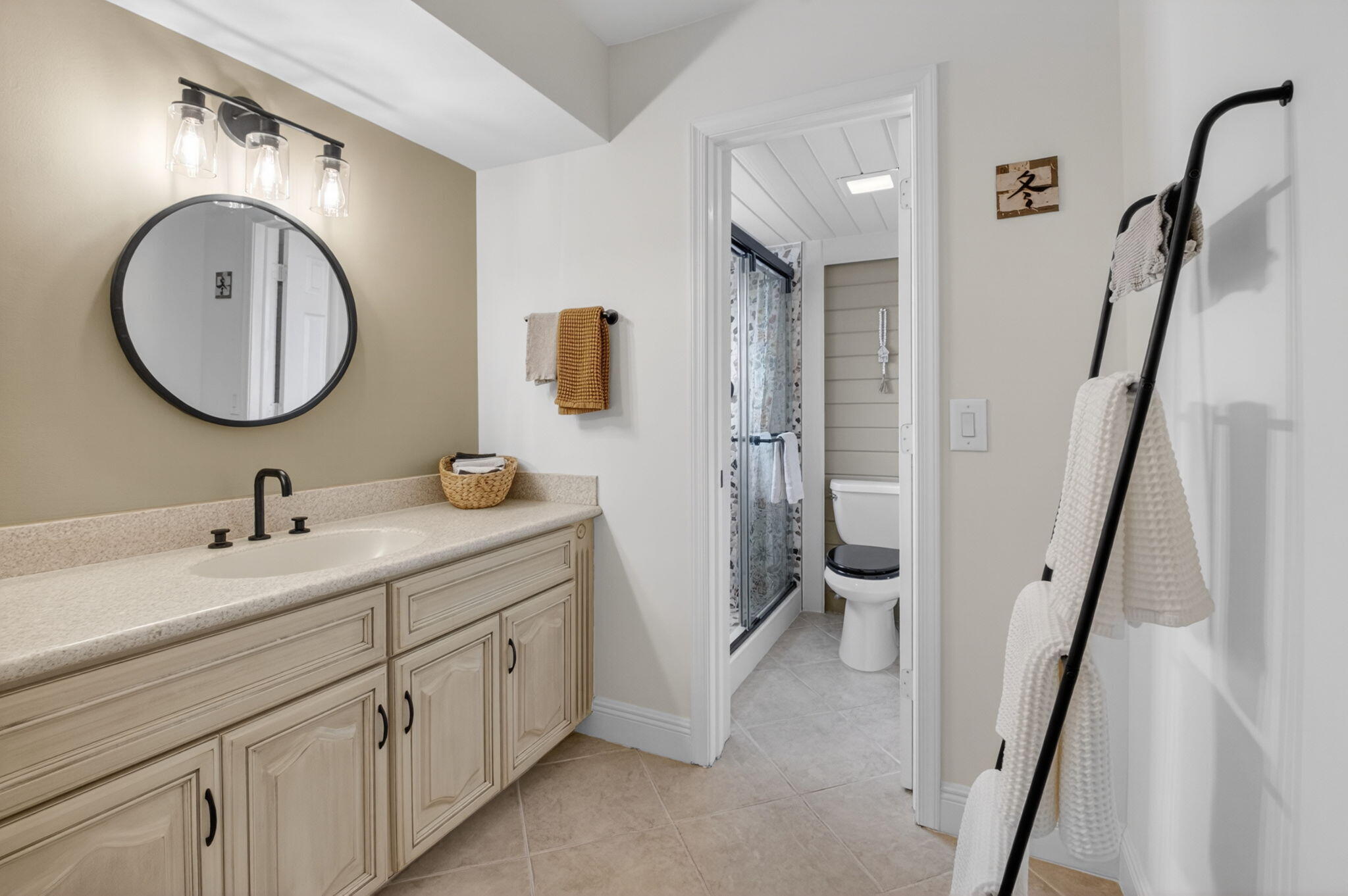 149 Northwest 70th Street, Unit 106C Boca Raton, FL 33487 - Photo 22 of 41 a en suite bathroom with a granite countertop sink and a mirror