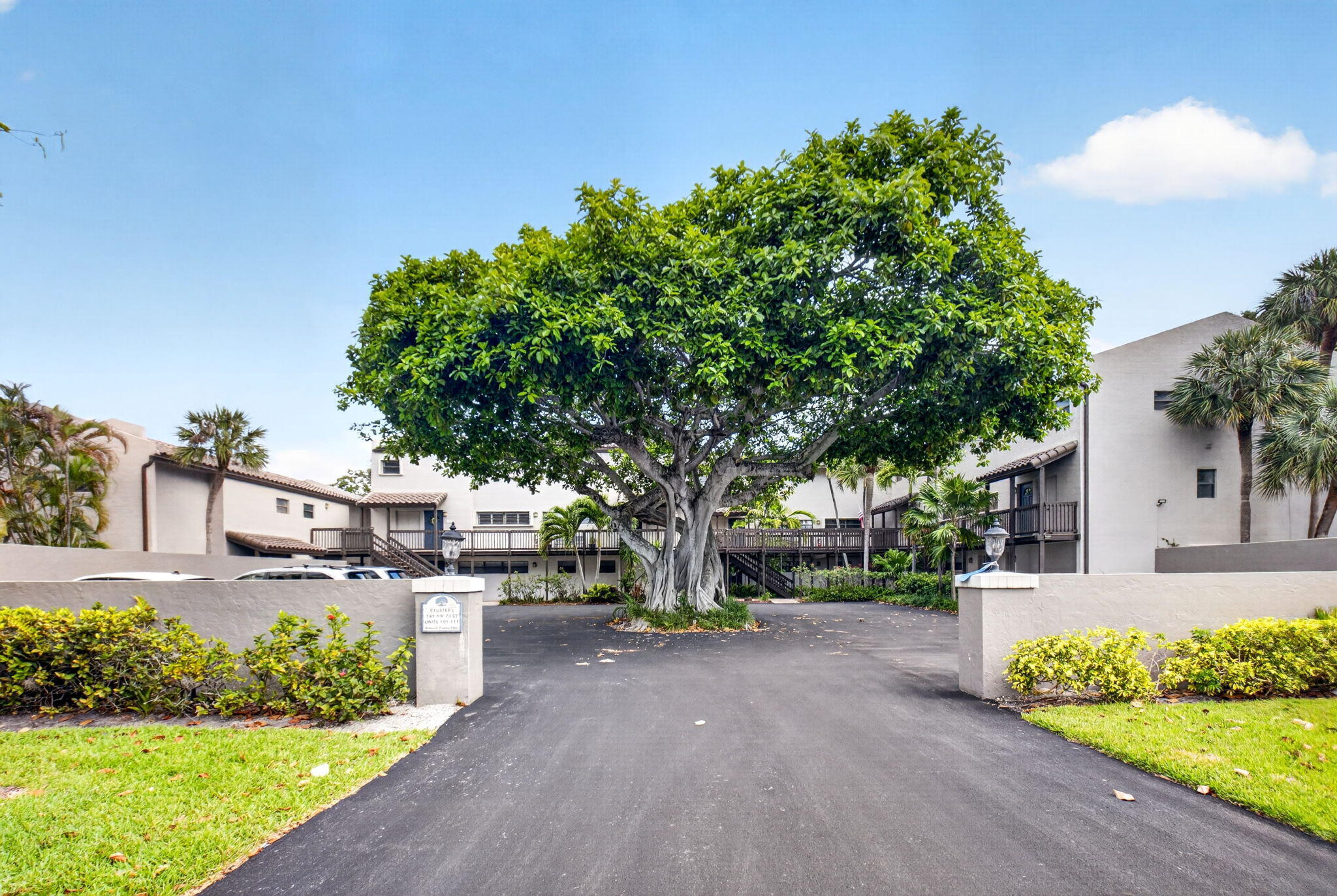149 Northwest 70th Street, Unit 106C Boca Raton, FL 33487 - Photo 40 of 41 a front view of a house with garden