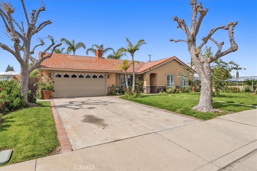 506 South Althea Avenue Rialto, CA 92376 - Photo 14 of 36 a front view of a house with a yard and garage