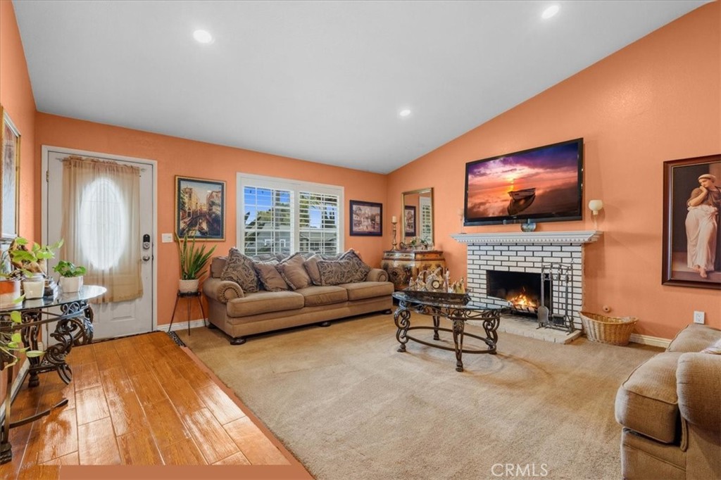 506 South Althea Avenue Rialto, CA 92376 - Photo 18 of 36 a living room with furniture a fireplace and a flat screen tv