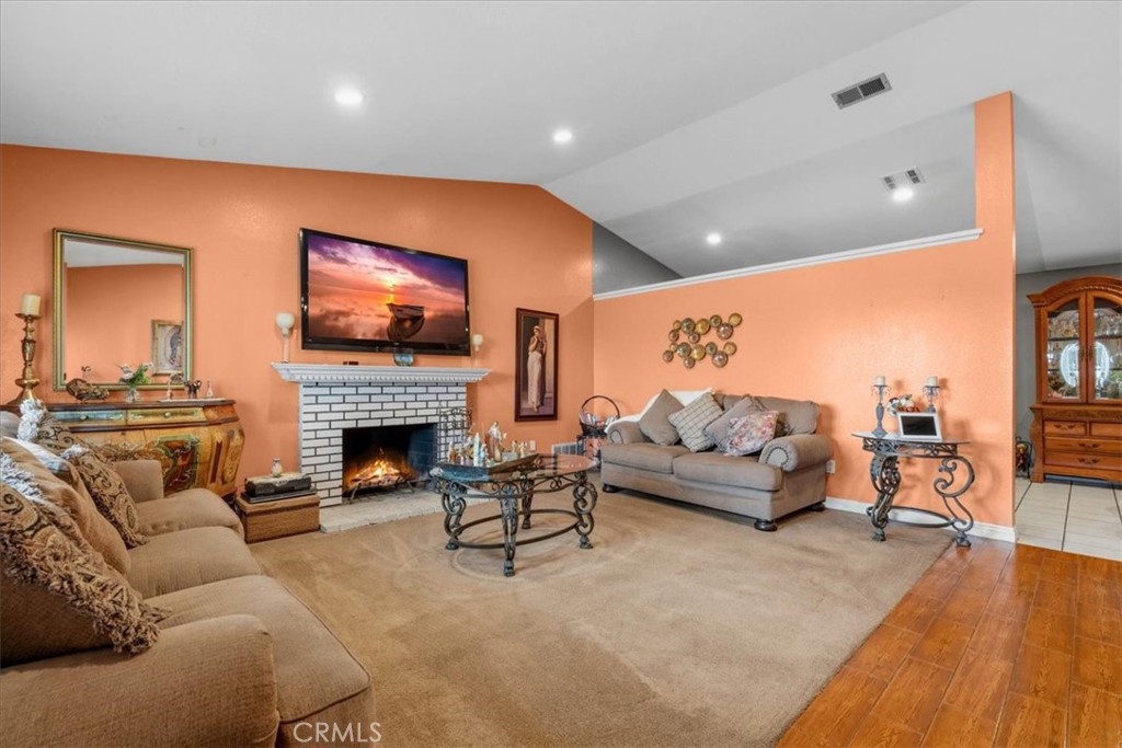 506 South Althea Avenue Rialto, CA 92376 - Photo 19 of 36 a living room with furniture a fireplace and a flat screen tv