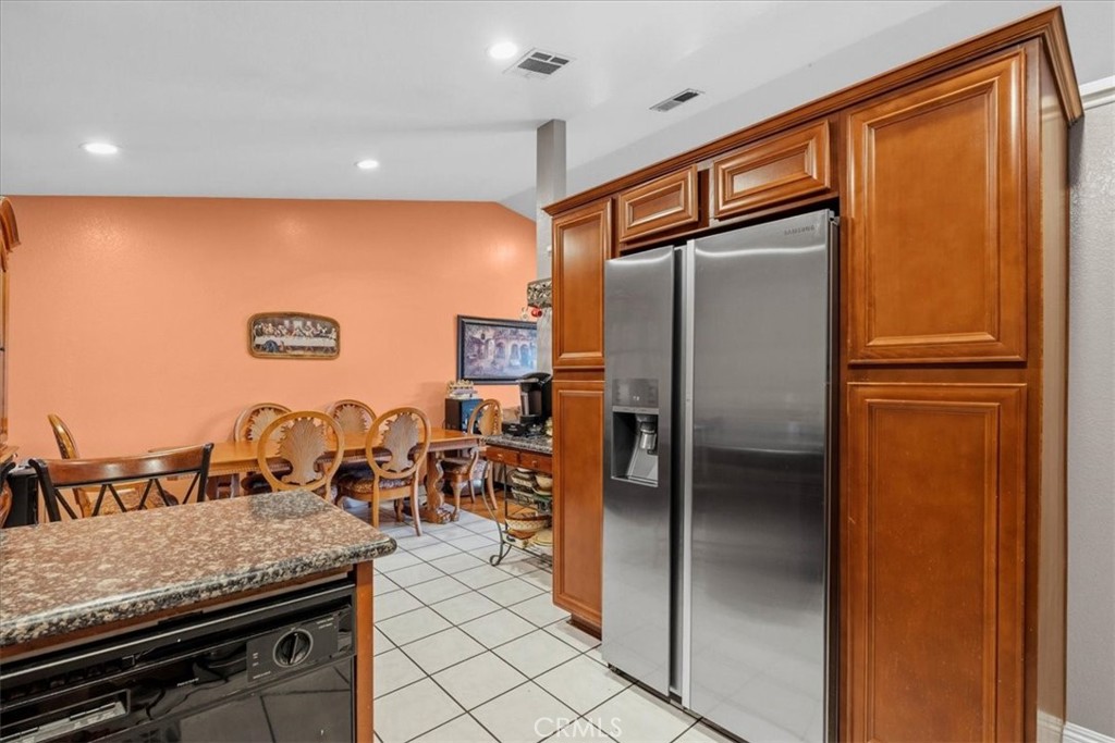 506 South Althea Avenue Rialto, CA 92376 - Photo 23 of 36 a kitchen with stainless steel appliances granite countertop a refrigerator a oven and a sink