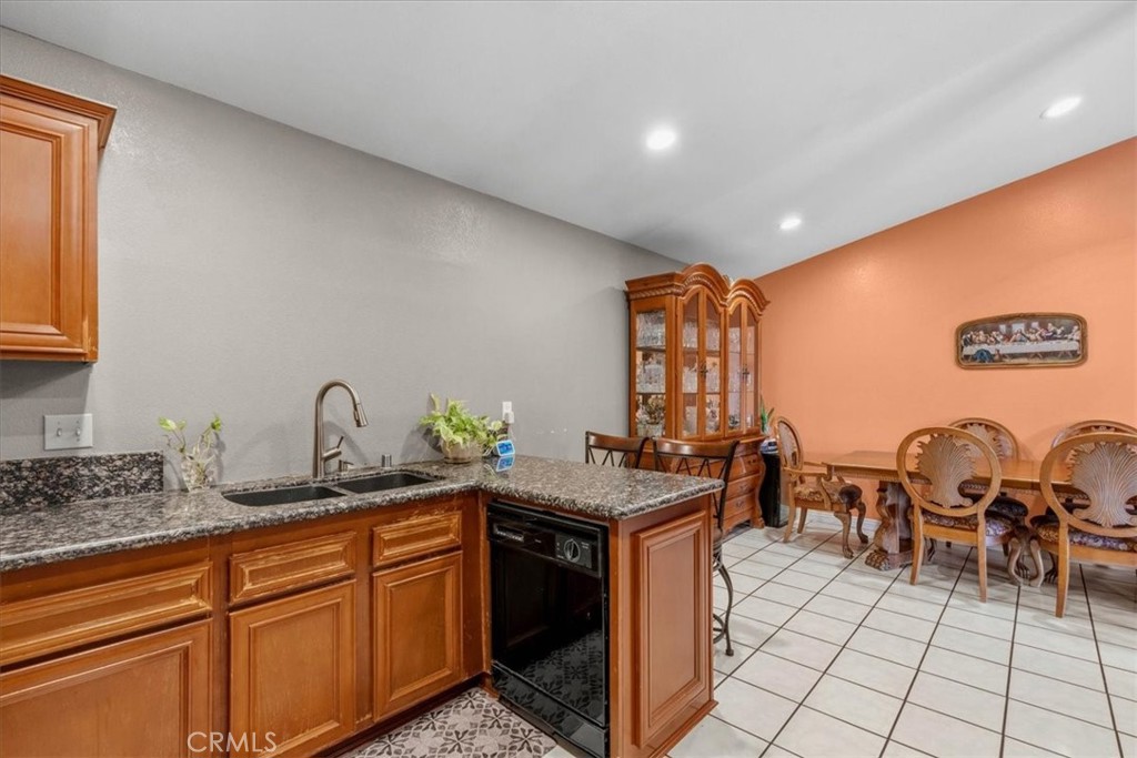 506 South Althea Avenue Rialto, CA 92376 - Photo 24 of 36 a kitchen with granite countertop a sink and cabinets
