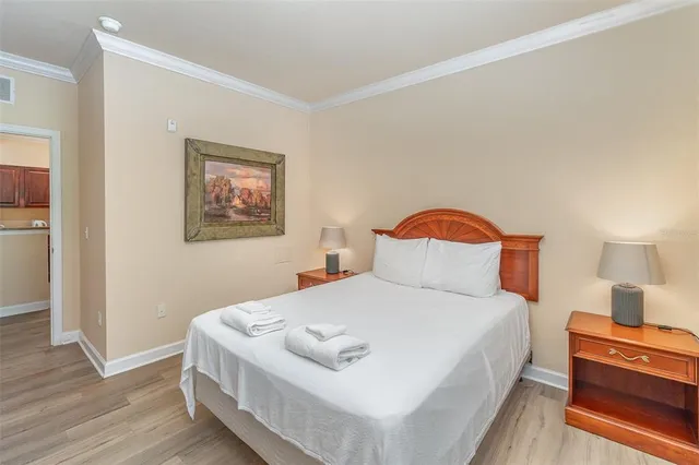 a bedroom with a bed and a lamp on table