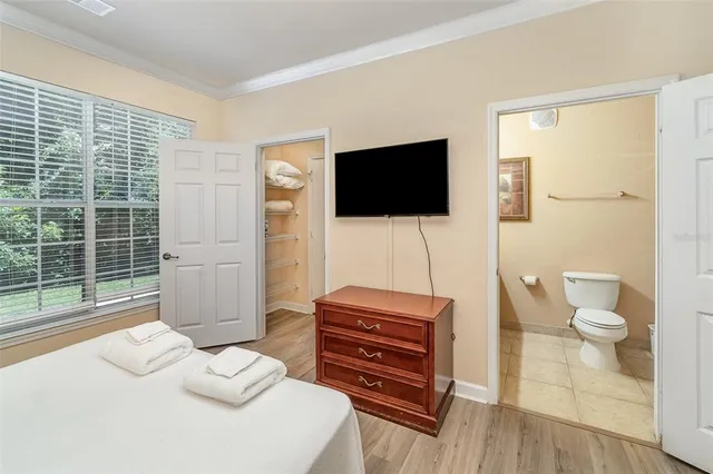 a living room with furniture a flat screen tv and a toilet