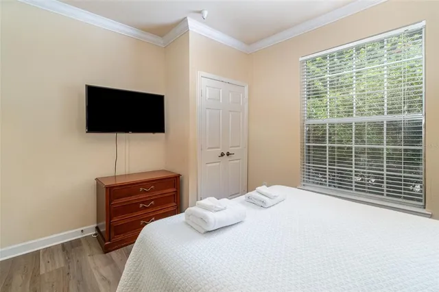 a bedroom with a bed and a flat screen tv