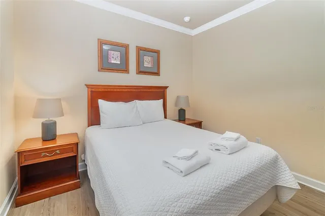 a bedroom with a bed and a night stand