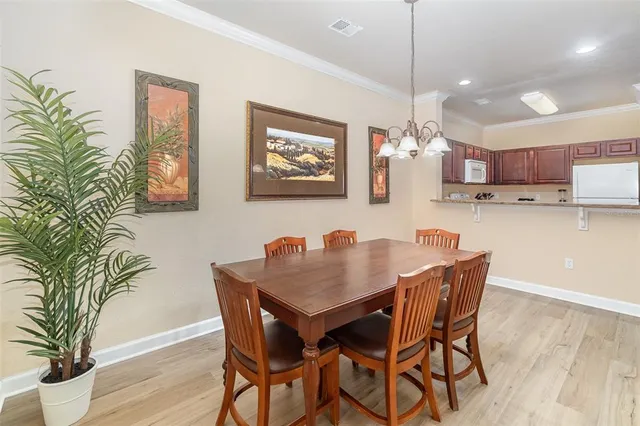 a view of a dining room with furniture and a potted plant