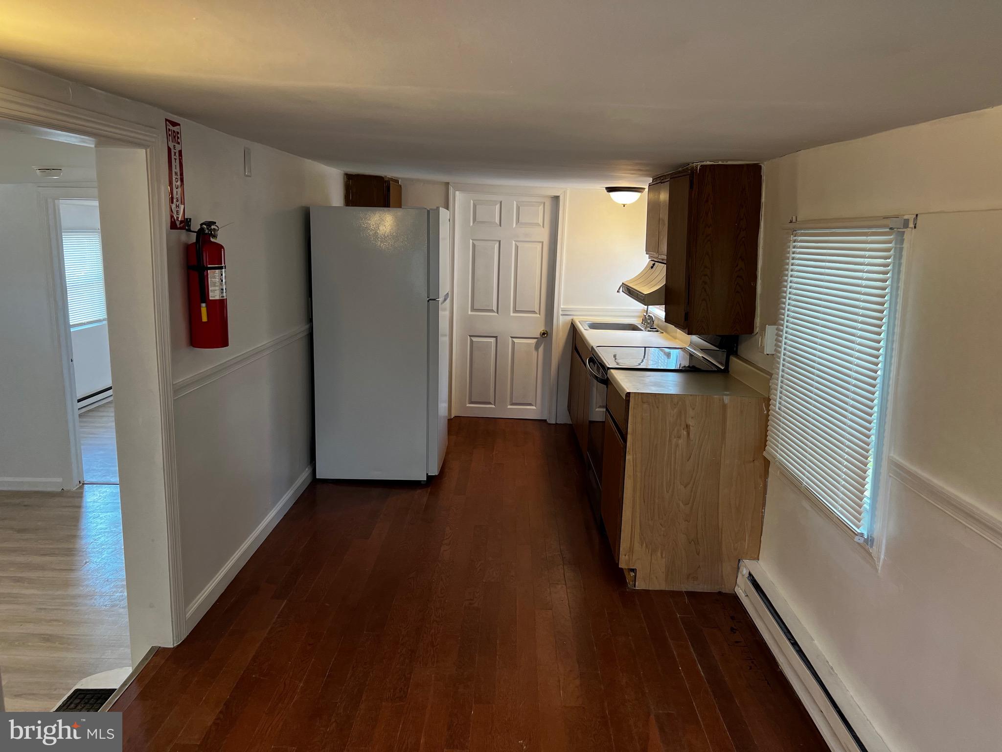 484 Harrison Avenue Mantua, NJ 08051 - Photo 11 of 14 a kitchen with a refrigerator and a stove top oven