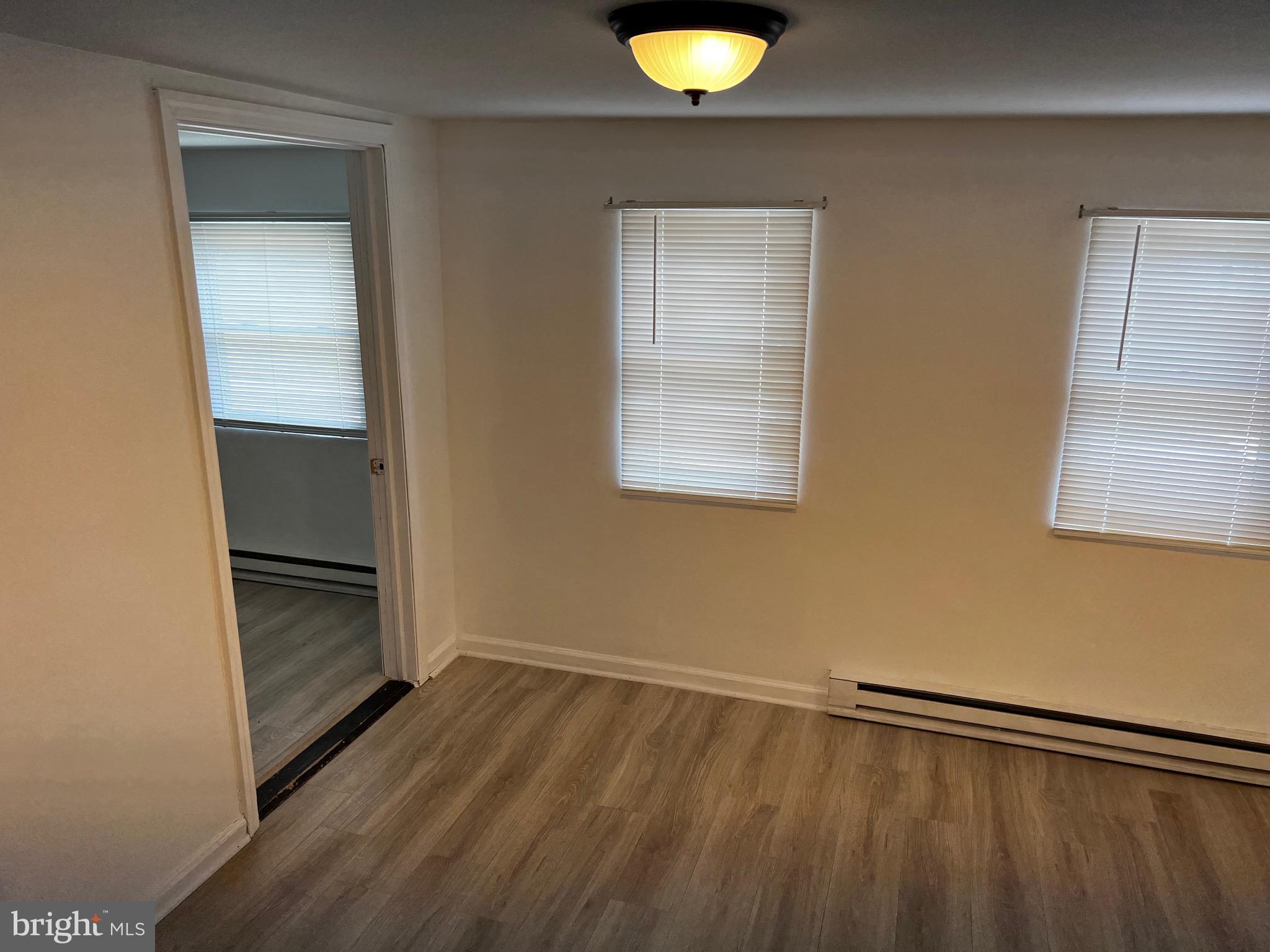 484 Harrison Avenue Mantua, NJ 08051 - Photo 13 of 14 a view of an empty room with wooden floor and a window