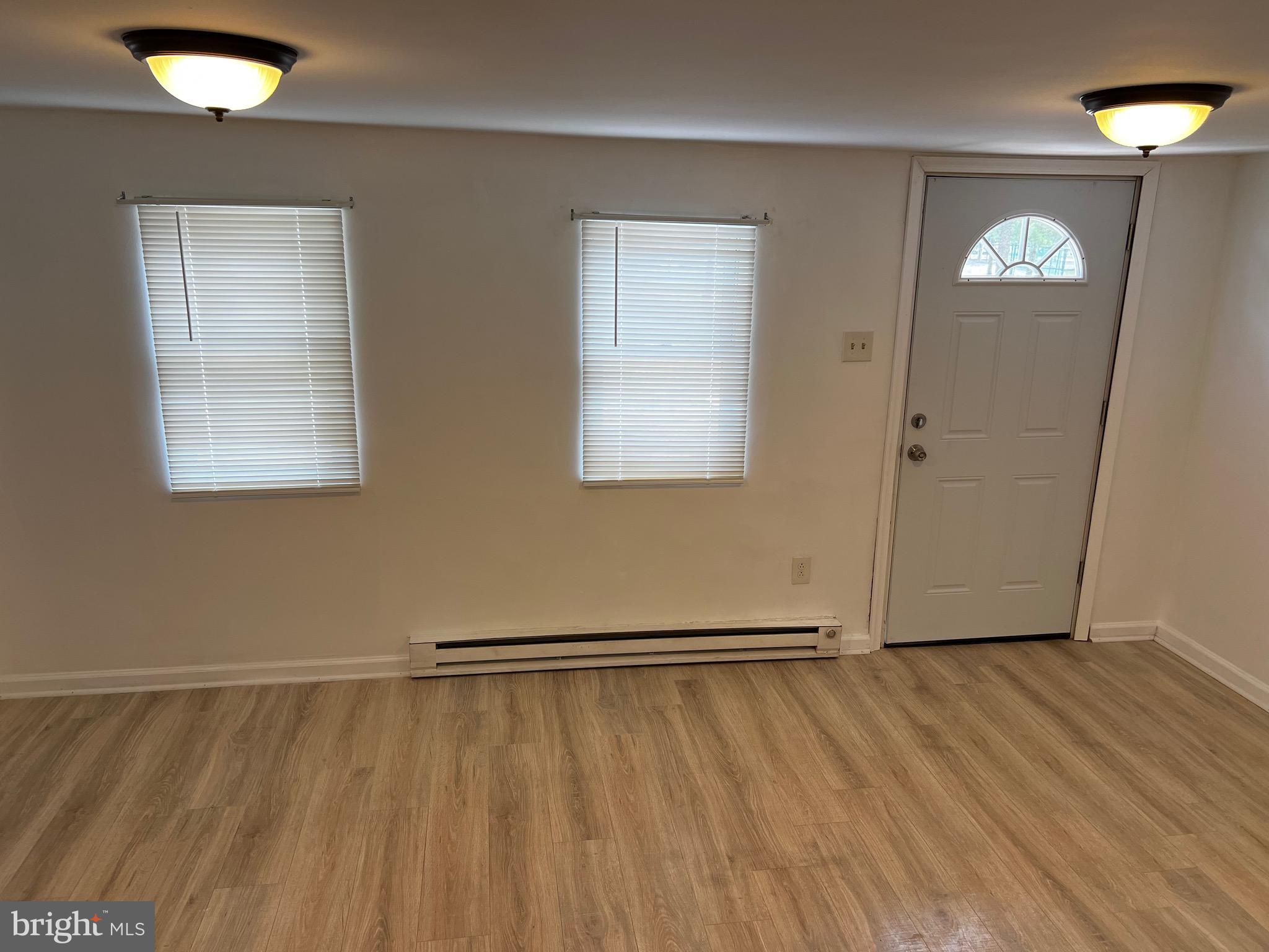 484 Harrison Avenue Mantua, NJ 08051 - Photo 14 of 14 an empty room with wooden floor and windows