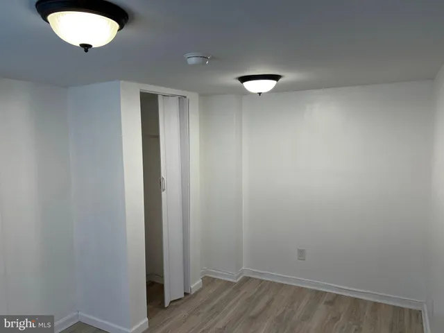 a view of a room with wooden floor and a sink