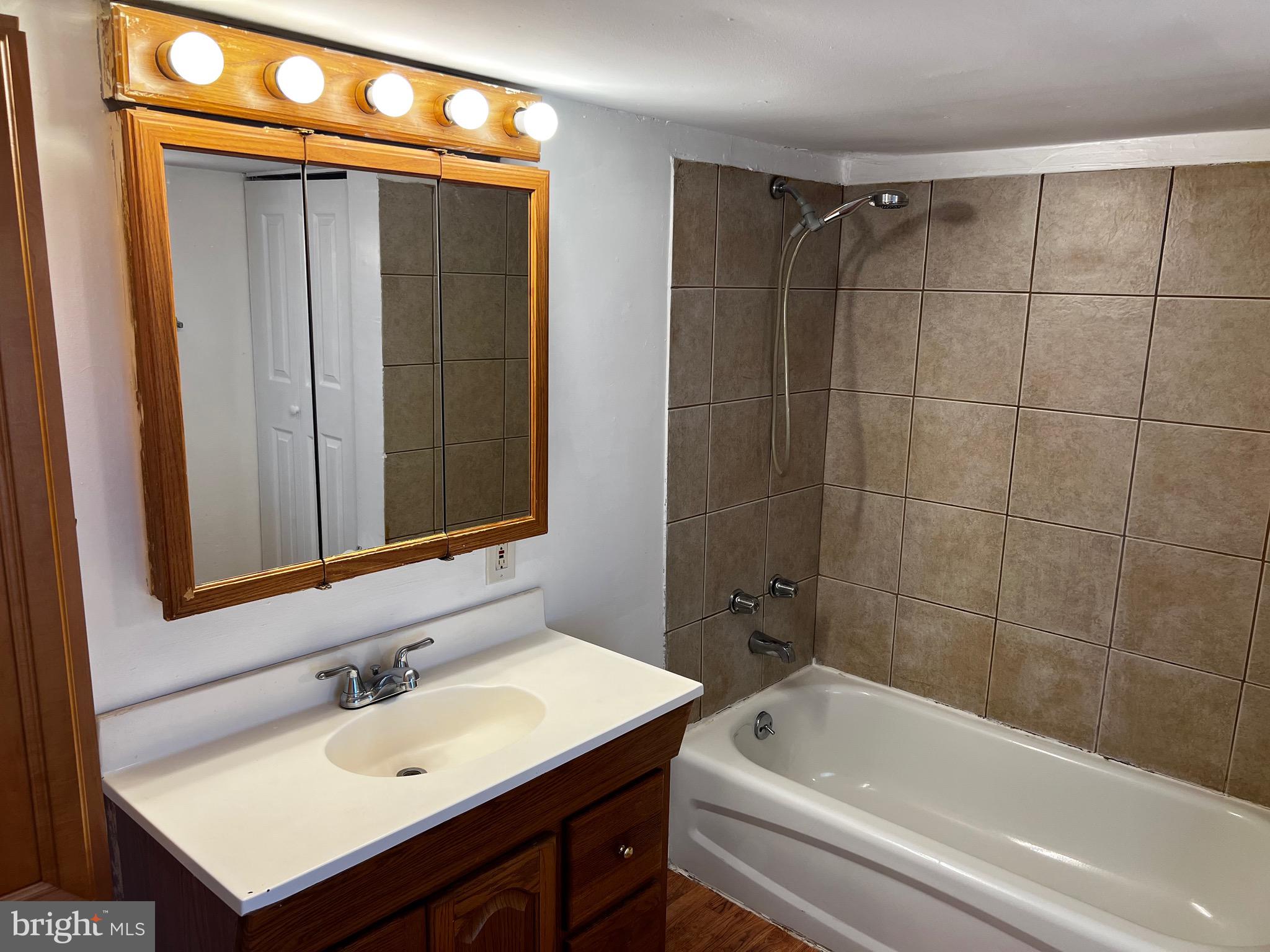 484 Harrison Avenue Mantua, NJ 08051 - Photo 8 of 14 a bathroom with a sink and a bathtub