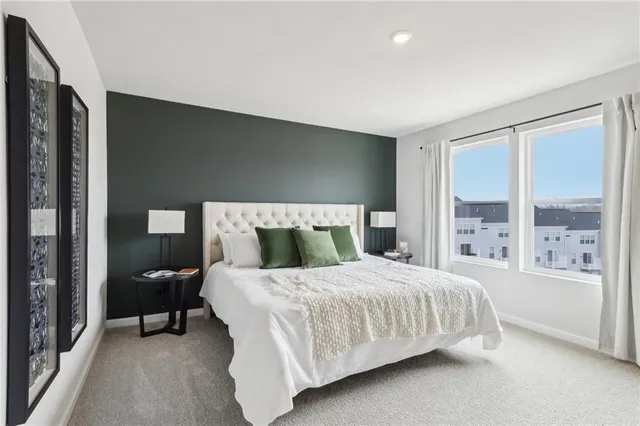 a bedroom with a large bed and a large window