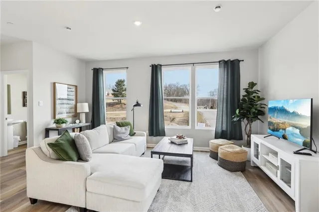 a living room with furniture and a large window