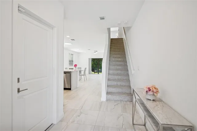 a room with a table and a chandelier