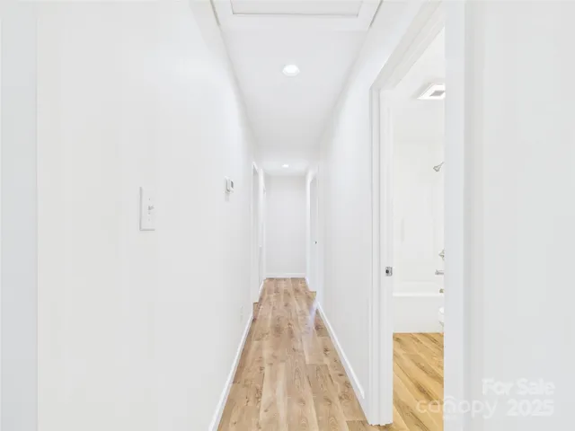 a view of a room with wooden floor