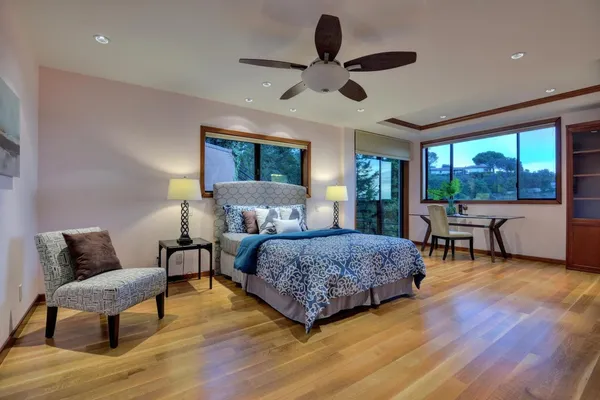 a bedroom with a bed and a large window