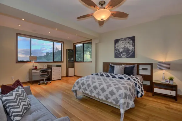 a bedroom with a large bed and a chandelier