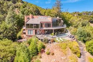 an aerial view of a house with a yard and lake view