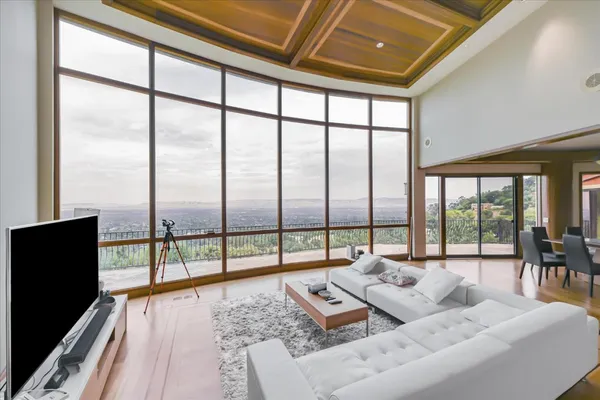 a living room with furniture and a floor to ceiling window