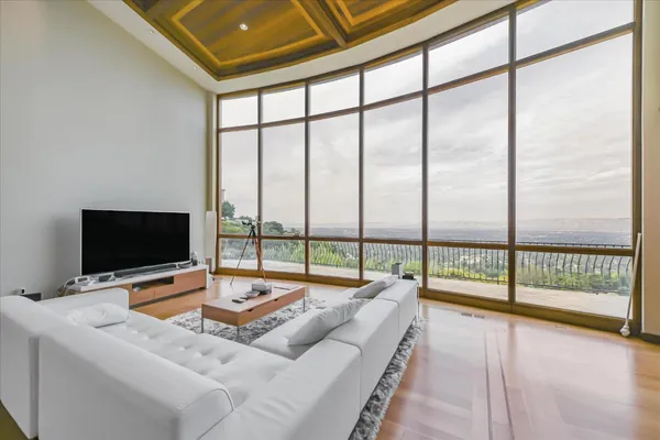 a living room with a large window and a flat screen tv