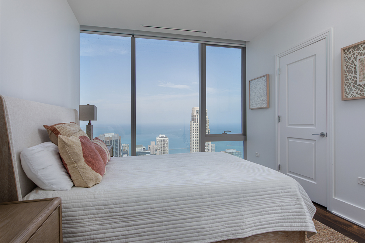 363 East Wacker Drive, Unit 5505 Chicago, IL 60601 - Photo 12 of 26 a bedroom with a bed and a night stand