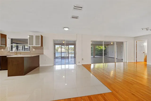 a large space with wooden floor and windows
