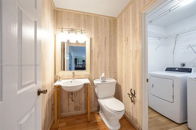 a bathroom with a toilet a sink and a mirror