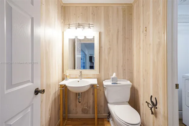 a bathroom with a sink a toilet and shower curtain