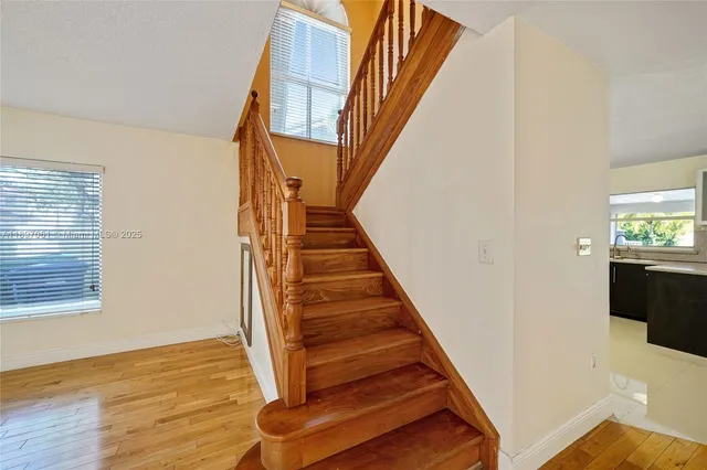 a view of entryway and hall with wooden floor