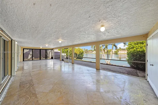 a view of an empty room with a floor to ceiling window