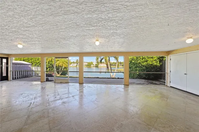 a view of an empty room with a fireplace and a large window