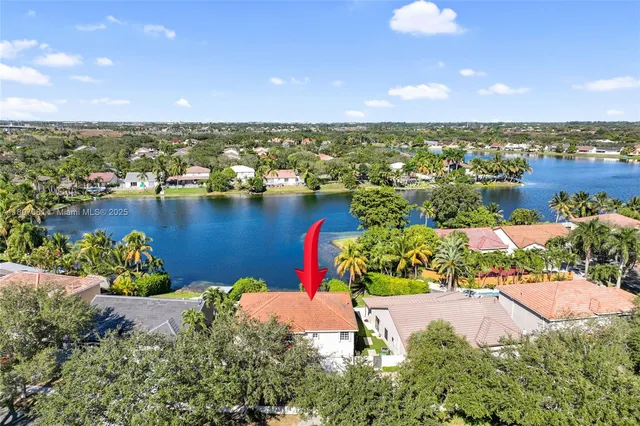 an aerial view of a house with a yard and fountain