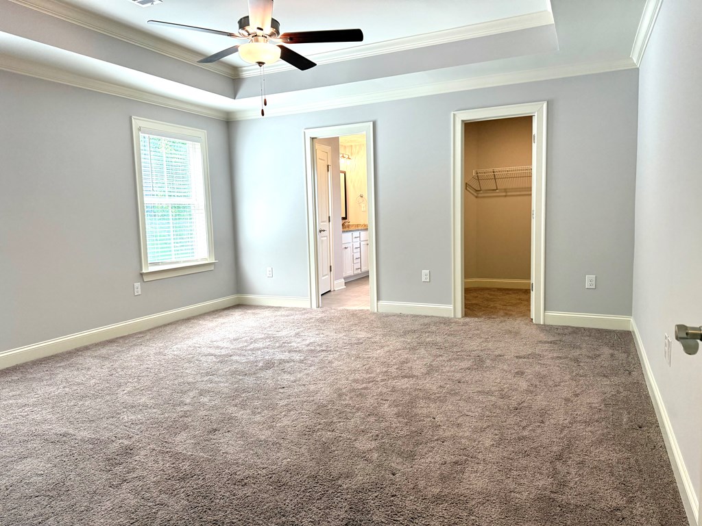 79 Altapass Way Fortson, GA 31808 - Photo 9 of 21 en empty room with windows and ceiling fan