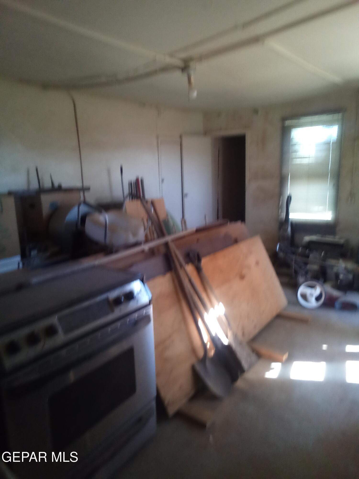 331 Dolan Street El Paso, TX 79905 - Photo 2 of 9 a projector room with furniture and a window