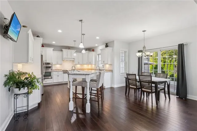 a dining room with furniture and wooden floor