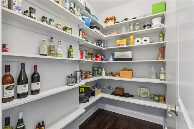 a room with a wooden floor and shelf