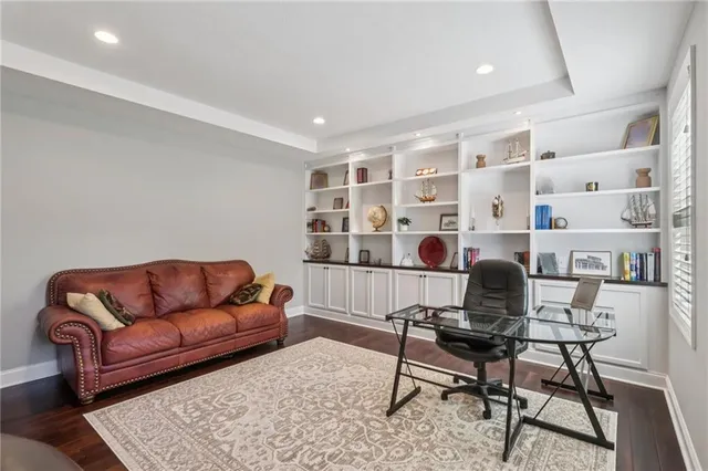 a work room with furniture and a rug